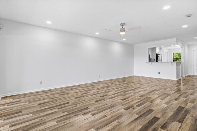 2920 SW 22nd Cir Unit C2, Delray Beach, FL 33445 - unfurnished living room with light wood-type flooring, recessed lighting, a ceiling fan, and baseboards