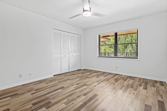 2920 SW 22nd Cir Unit C2, Delray Beach, FL 33445 - unfurnished bedroom with a closet, wood finished floors, baseboards, and a ceiling fan