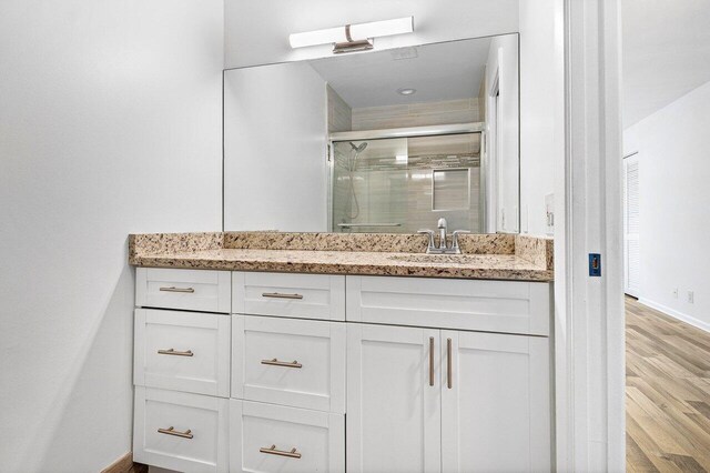 2920 SW 22nd Cir Unit C2, Delray Beach, FL 33445 - full bathroom with a shower stall, wood finished floors, baseboards, and vanity