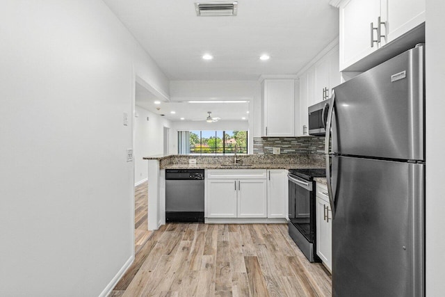 2920 SW 22nd Cir Unit C2, Delray Beach, FL 33445 - kitchen featuring appliances with stainless steel finishes, a sink, light wood-style flooring, white cabinetry, and recessed lighting