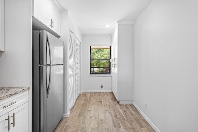 2920 SW 22nd Cir Unit C2, Delray Beach, FL 33445 - kitchen with freestanding refrigerator, light wood finished floors, white cabinetry, baseboards, and recessed lighting