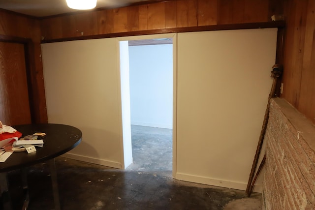 unfurnished dining area featuring concrete floors and baseboards