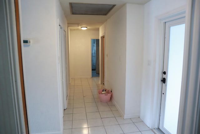 hall with light tile patterned floors and baseboards
