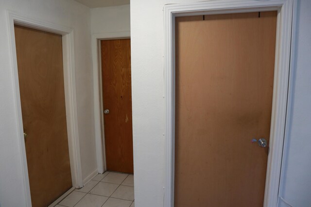 hall with light tile patterned flooring