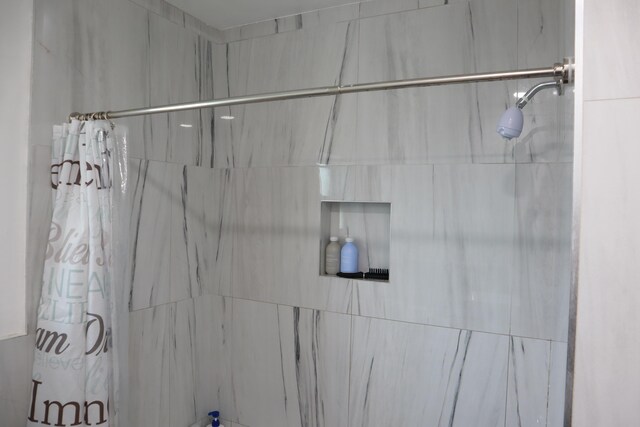 bathroom with tiled shower
