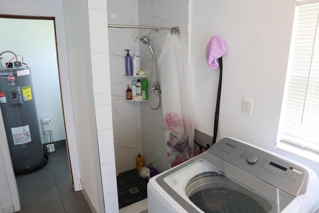 clothes washing area with washer / dryer, electric water heater, and tile patterned flooring