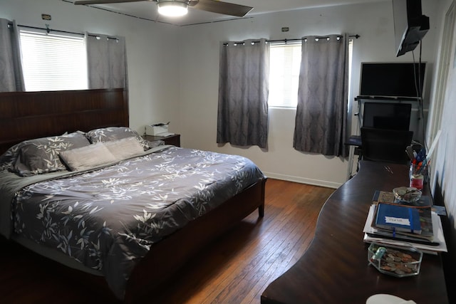 bedroom featuring wood-type flooring and baseboards