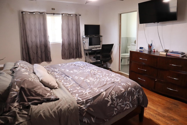 bedroom with wood finished floors and ensuite bathroom