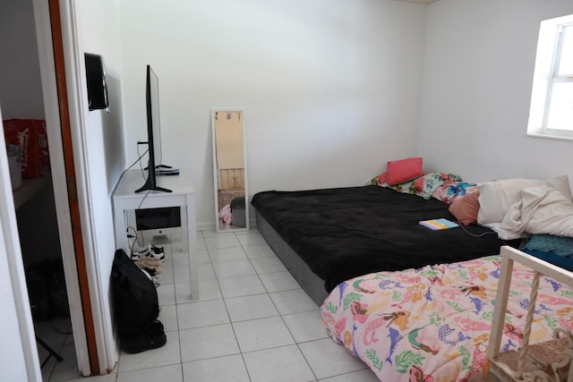 bedroom featuring light tile patterned floors