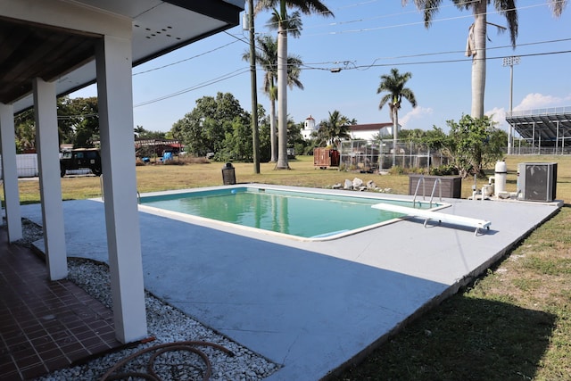 view of pool featuring a patio and a diving board