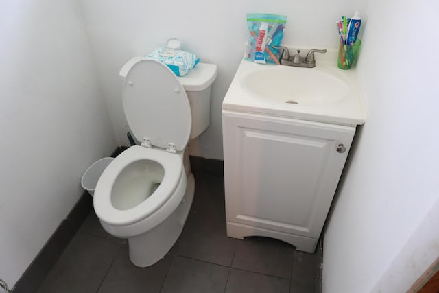 bathroom featuring toilet, vanity, and tile patterned floors