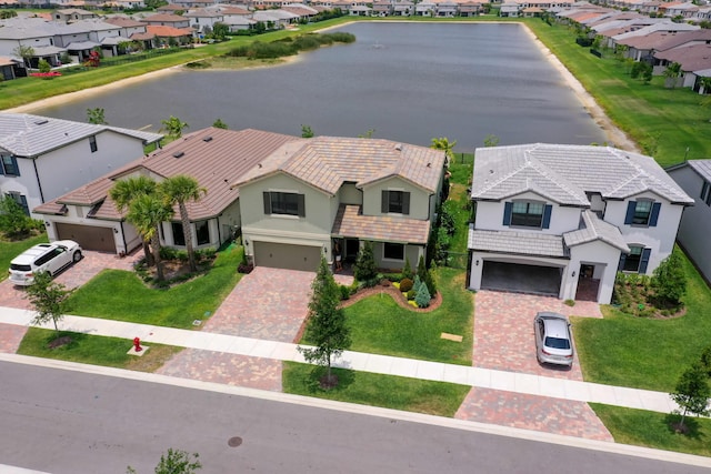 aerial view of residential area featuring a large body of water