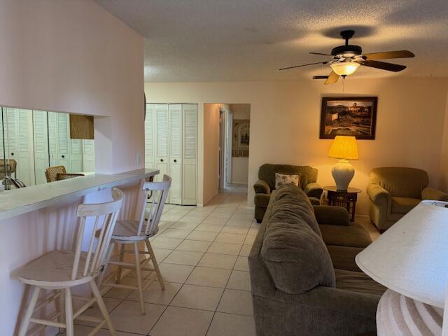 4065 NW Cinnamon Tree Cir, Jensen Beach, FL 34957 - living room featuring ceiling fan and light tile patterned flooring