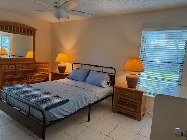 4065 NW Cinnamon Tree Cir, Jensen Beach, FL 34957 - bedroom featuring multiple windows, a textured ceiling, light tile patterned floors, and ceiling fan