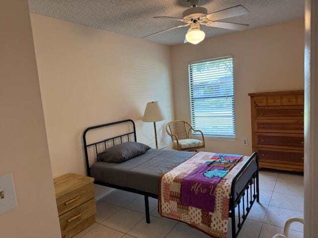 4065 NW Cinnamon Tree Cir, Jensen Beach, FL 34957 - bedroom with a textured ceiling, light tile patterned flooring, and a ceiling fan
