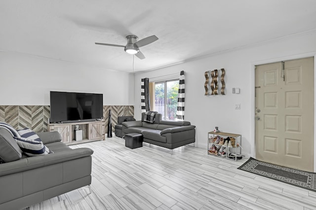 living area featuring a ceiling fan, wood finished floors, and baseboards