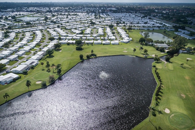aerial view of property's location featuring a nearby body of water, a local golf course, and nearby suburban area