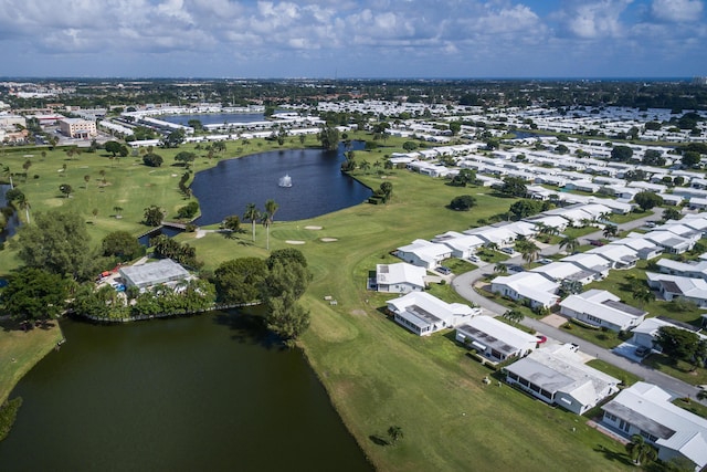 aerial view of property's location with a nearby body of water, a golf club, and nearby suburban area