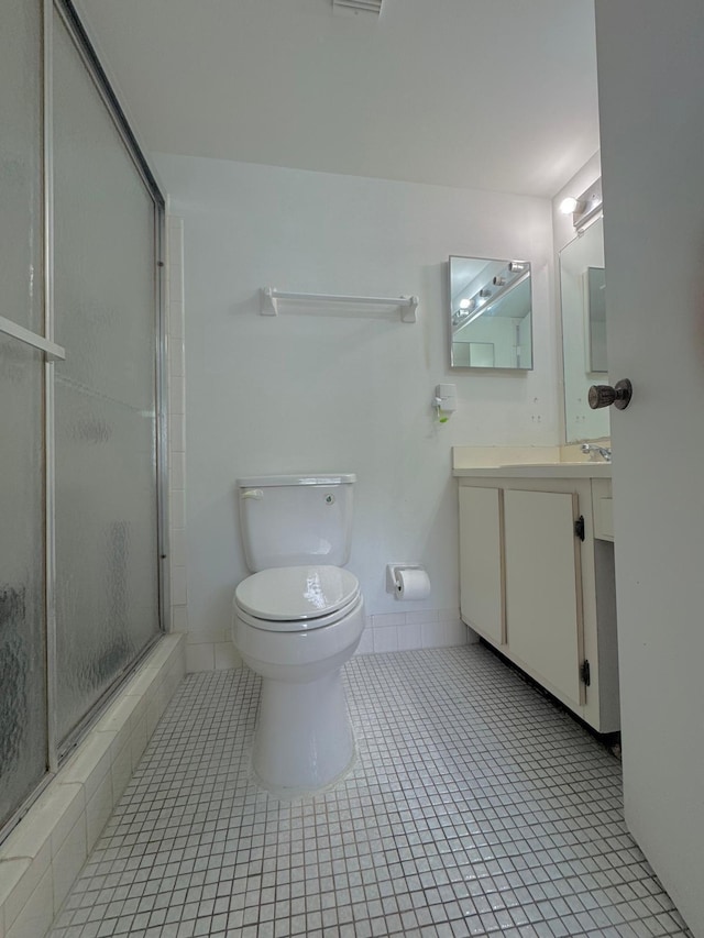 8305 NW 61st St Unit C309, Tamarac, FL 33321 - full bath with vanity, a shower with shower door, tile patterned flooring, and toilet