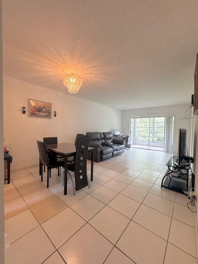 8305 NW 61st St Unit C309, Tamarac, FL 33321 - dining space featuring a textured ceiling, light tile patterned floors, and a chandelier