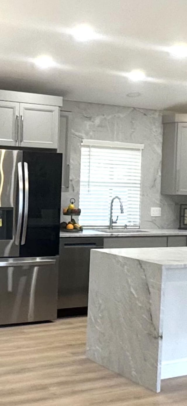 889 SW Nichols Ter, Port Saint Lucie, FL 34953 - kitchen featuring appliances with stainless steel finishes, gray cabinetry, a sink, and open shelves