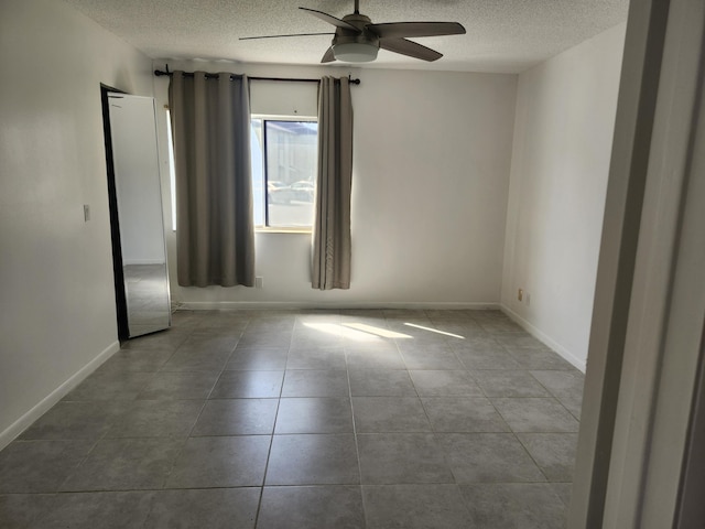3587 La Playas Ct Unit A-1, Greenacres, FL 33463 - tiled empty room featuring a textured ceiling, ceiling fan, and baseboards