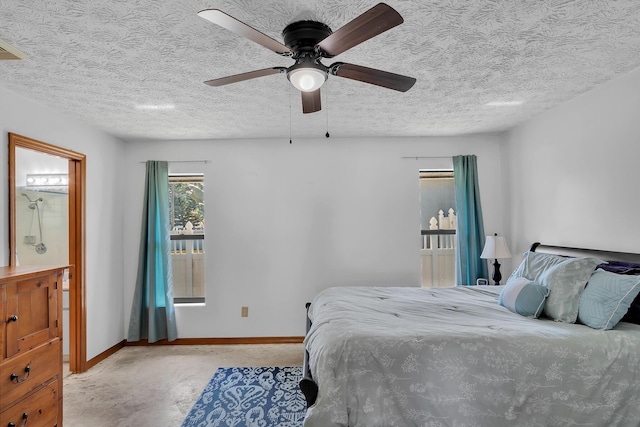 1290 SE Mcfarlane Ave, Port Saint Lucie, FL 34952 - bedroom with a textured ceiling, baseboards, ceiling fan, and ensuite bathroom