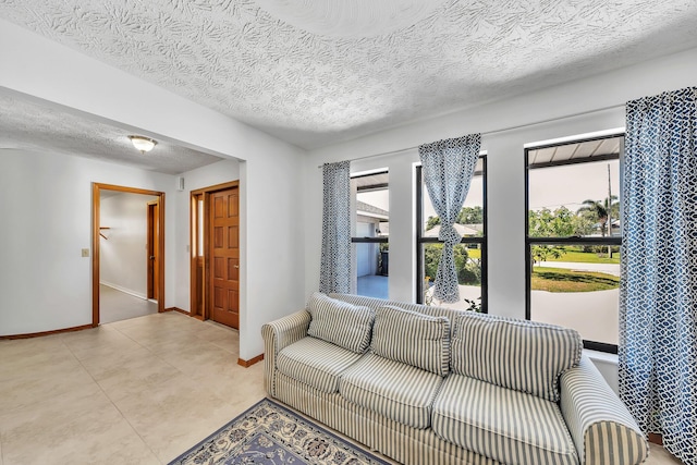 1290 SE Mcfarlane Ave, Port Saint Lucie, FL 34952 - living area featuring a textured ceiling and baseboards