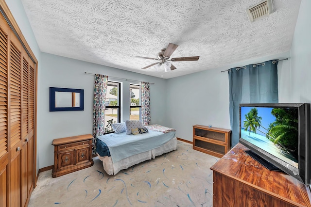 1290 SE Mcfarlane Ave, Port Saint Lucie, FL 34952 - bedroom with a closet, concrete flooring, baseboards, a ceiling fan, and a textured ceiling