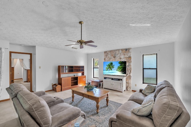 1290 SE Mcfarlane Ave, Port Saint Lucie, FL 34952 - living area with ceiling fan, a textured ceiling, baseboards, and light tile patterned floors