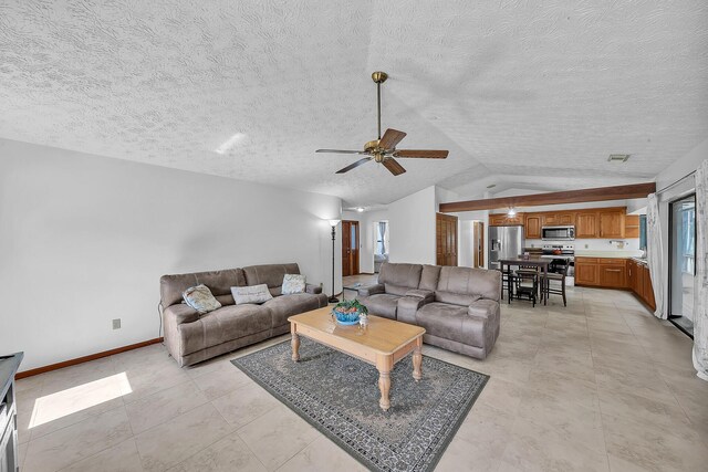 1290 SE Mcfarlane Ave, Port Saint Lucie, FL 34952 - living room featuring vaulted ceiling, a ceiling fan, baseboards, and a textured ceiling
