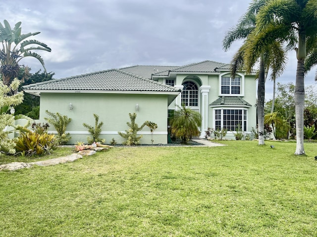 15511 63rd Pl N, Loxahatchee, FL 33470 - back of house featuring stucco siding, a yard, and a tile roof