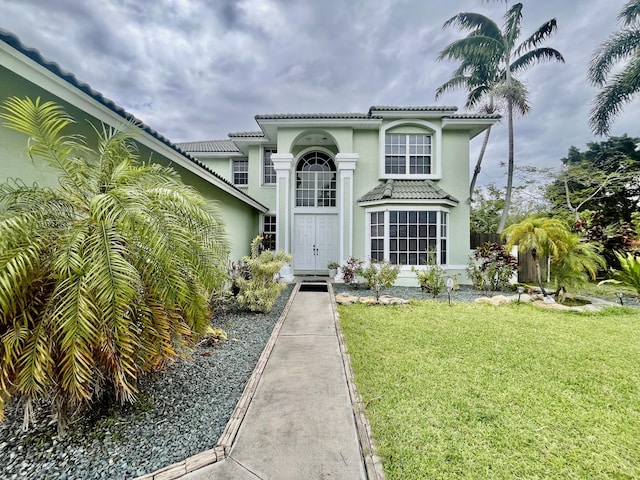 15511 63rd Pl N, Loxahatchee, FL 33470 - view of front of home featuring a front lawn, stucco siding, and a tiled roof