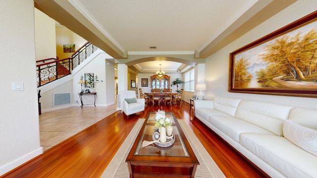 15511 63rd Pl N, Loxahatchee, FL 33470 - living area featuring arched walkways, wood finished floors, ornamental molding, stairs, and baseboards