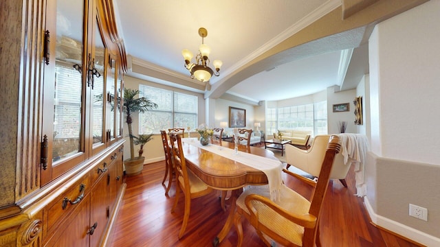 15511 63rd Pl N, Loxahatchee, FL 33470 - dining space with wood finished floors, baseboards, a chandelier, arched walkways, and crown molding