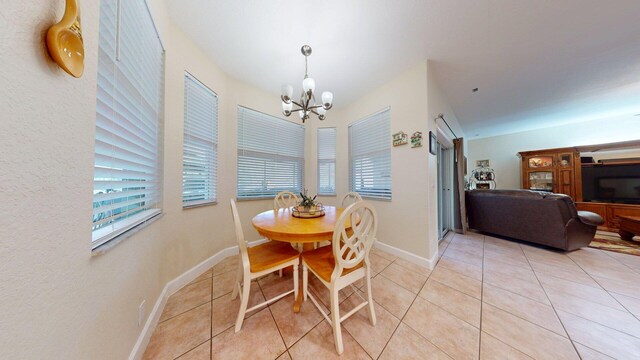15511 63rd Pl N, Loxahatchee, FL 33470 - dining space featuring a chandelier, light tile patterned floors, and baseboards