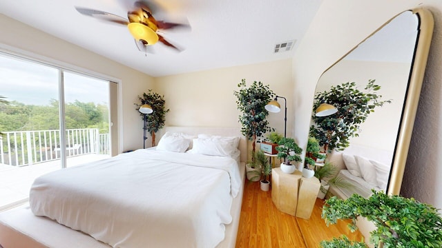 15511 63rd Pl N, Loxahatchee, FL 33470 - bedroom featuring access to exterior, wood finished floors, and a ceiling fan