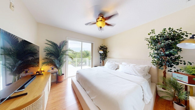 15511 63rd Pl N, Loxahatchee, FL 33470 - bedroom with access to exterior, light wood-type flooring, and a ceiling fan