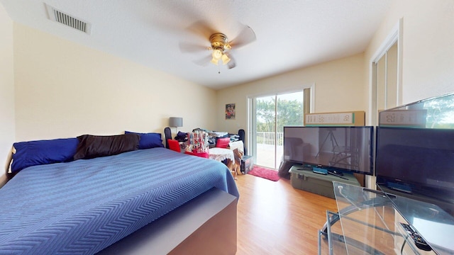 15511 63rd Pl N, Loxahatchee, FL 33470 - bedroom featuring wood finished floors, access to exterior, and a ceiling fan