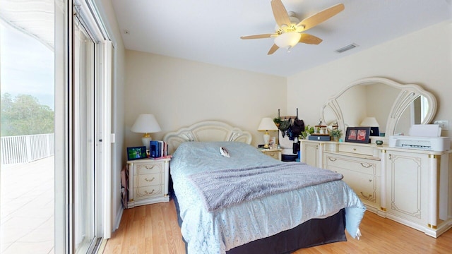 15511 63rd Pl N, Loxahatchee, FL 33470 - bedroom featuring access to exterior, light wood-style floors, and a ceiling fan