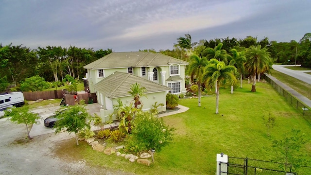 15511 63rd Pl N, Loxahatchee, FL 33470 - back of property featuring a tile roof, an attached garage, and driveway