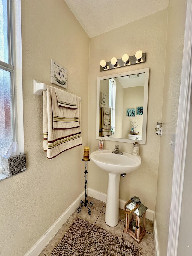 15511 63rd Pl N, Loxahatchee, FL 33470 - bathroom with tile patterned flooring, baseboards, a sink, and a textured wall