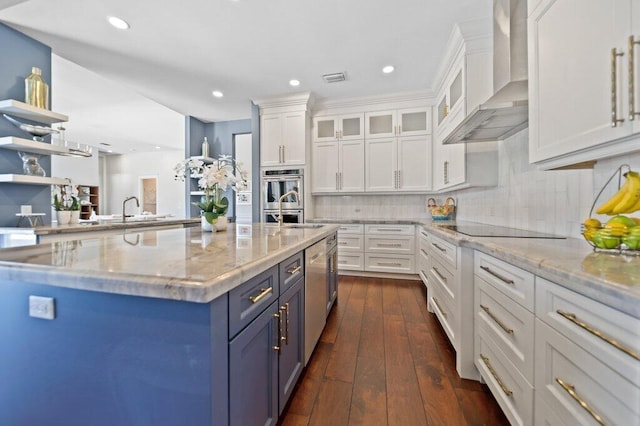 5211 SW Bimini Cir N, Palm City, FL 34990 - kitchen with wall chimney exhaust hood, white cabinetry, recessed lighting, light stone countertops, and backsplash