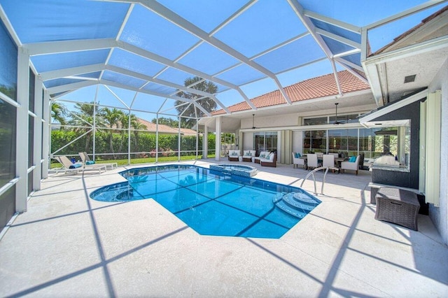 5211 SW Bimini Cir N, Palm City, FL 34990 - view of pool with an outdoor hangout area, a patio, a pool with connected hot tub, and glass enclosure