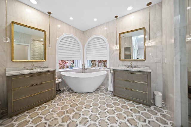 5211 SW Bimini Cir N, Palm City, FL 34990 - full bathroom with tile walls, two vanities, and a freestanding bath