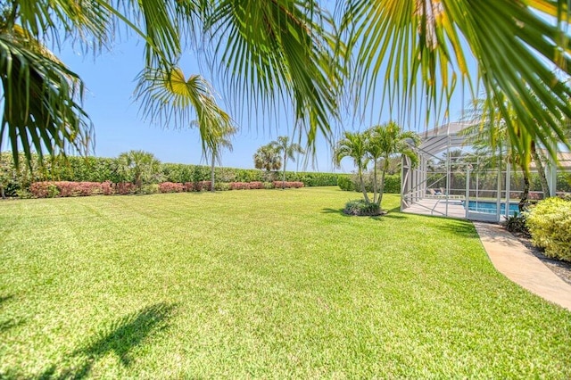 5211 SW Bimini Cir N, Palm City, FL 34990 - view of grassy yard with an outdoor pool and glass enclosure