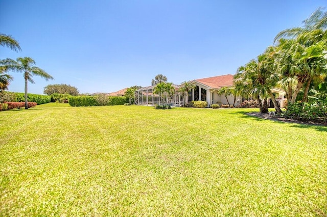 5211 SW Bimini Cir N, Palm City, FL 34990 - view of grassy yard with glass enclosure