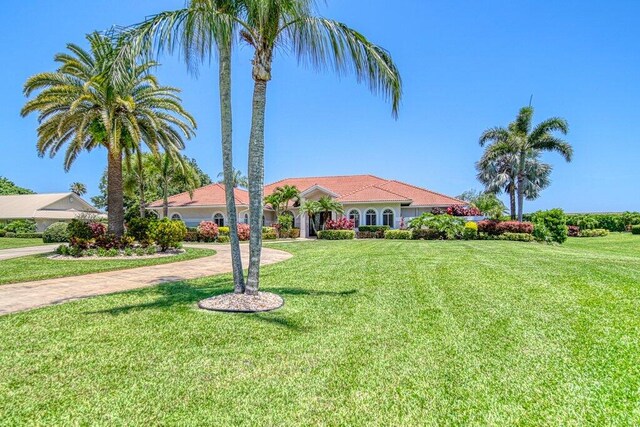 5211 SW Bimini Cir N, Palm City, FL 34990 - mediterranean / spanish home featuring a front yard