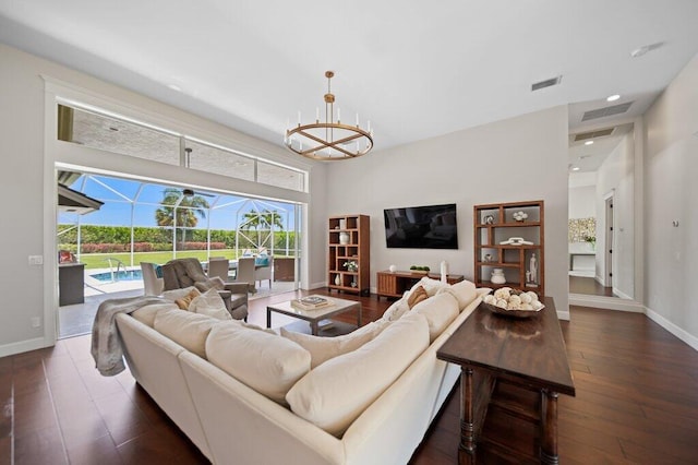 5211 SW Bimini Cir N, Palm City, FL 34990 - living area with a sunroom, dark wood-style flooring, baseboards, a chandelier, and recessed lighting