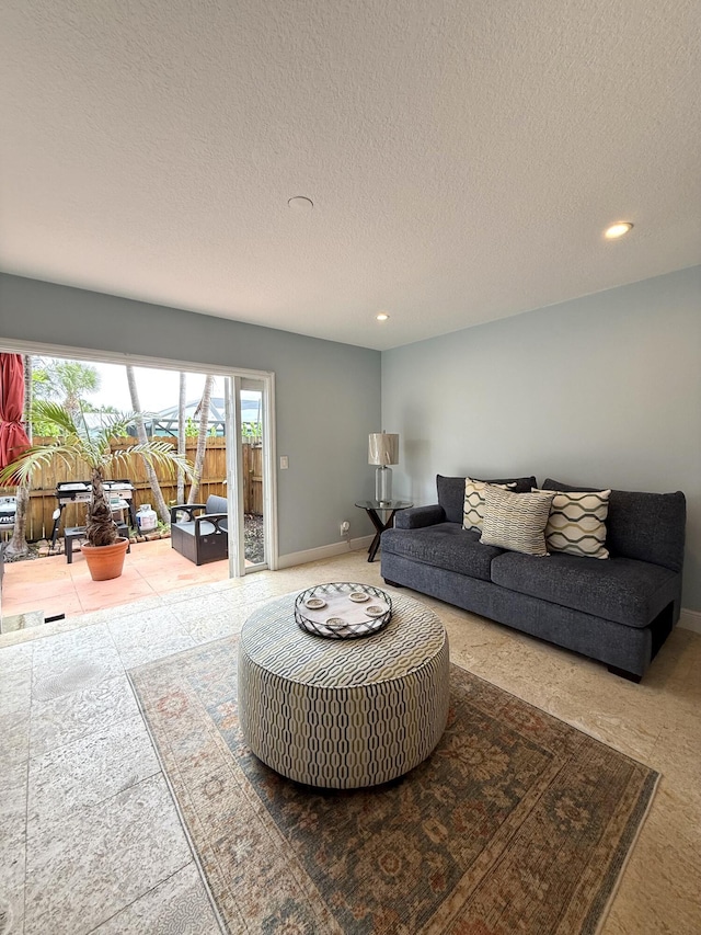 carpeted living room featuring recessed lighting, baseboards, and a textured ceiling